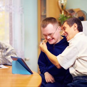 happy friends with disability socializing through internet